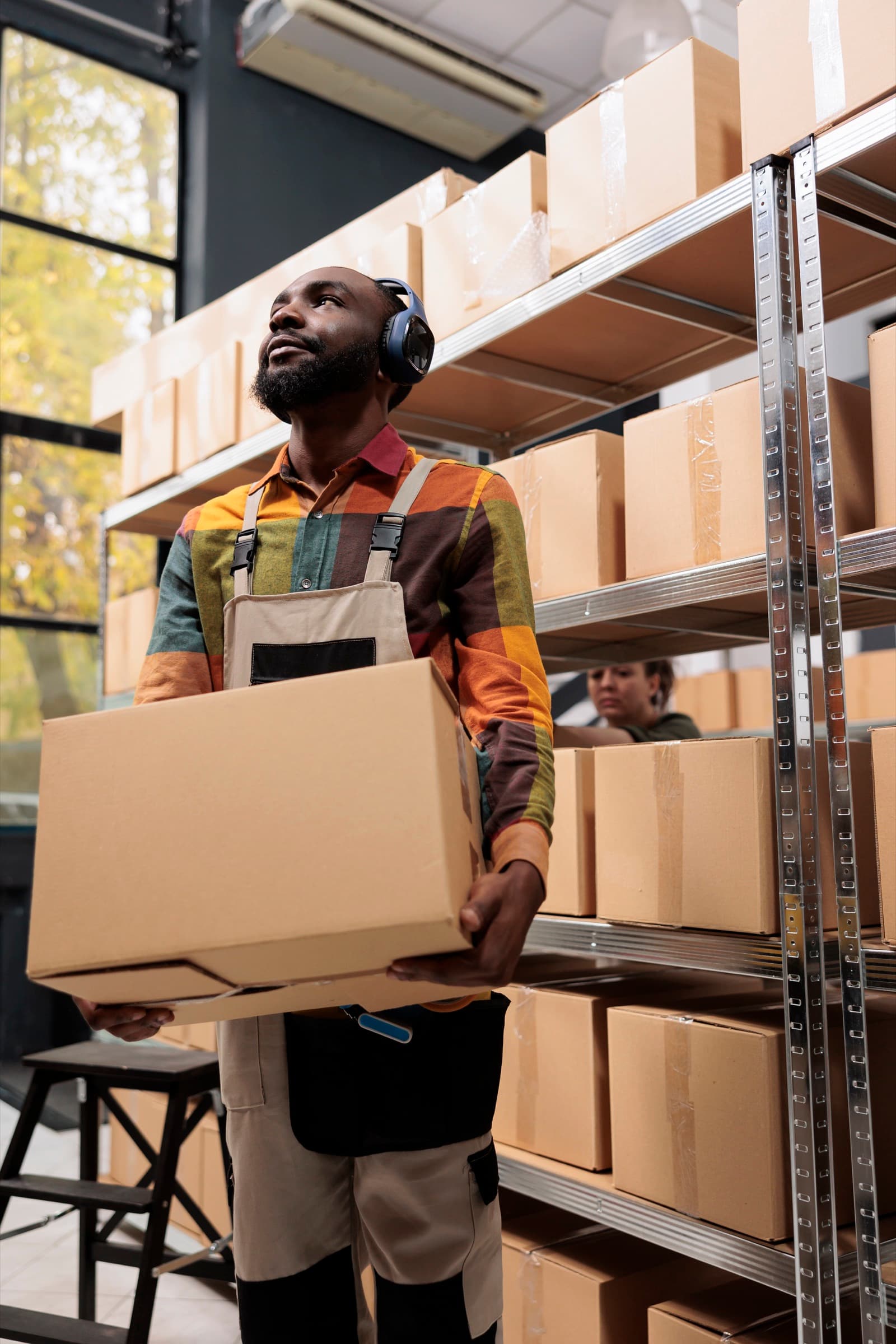 Duolink Logistics team member carrying packages in the warehouse